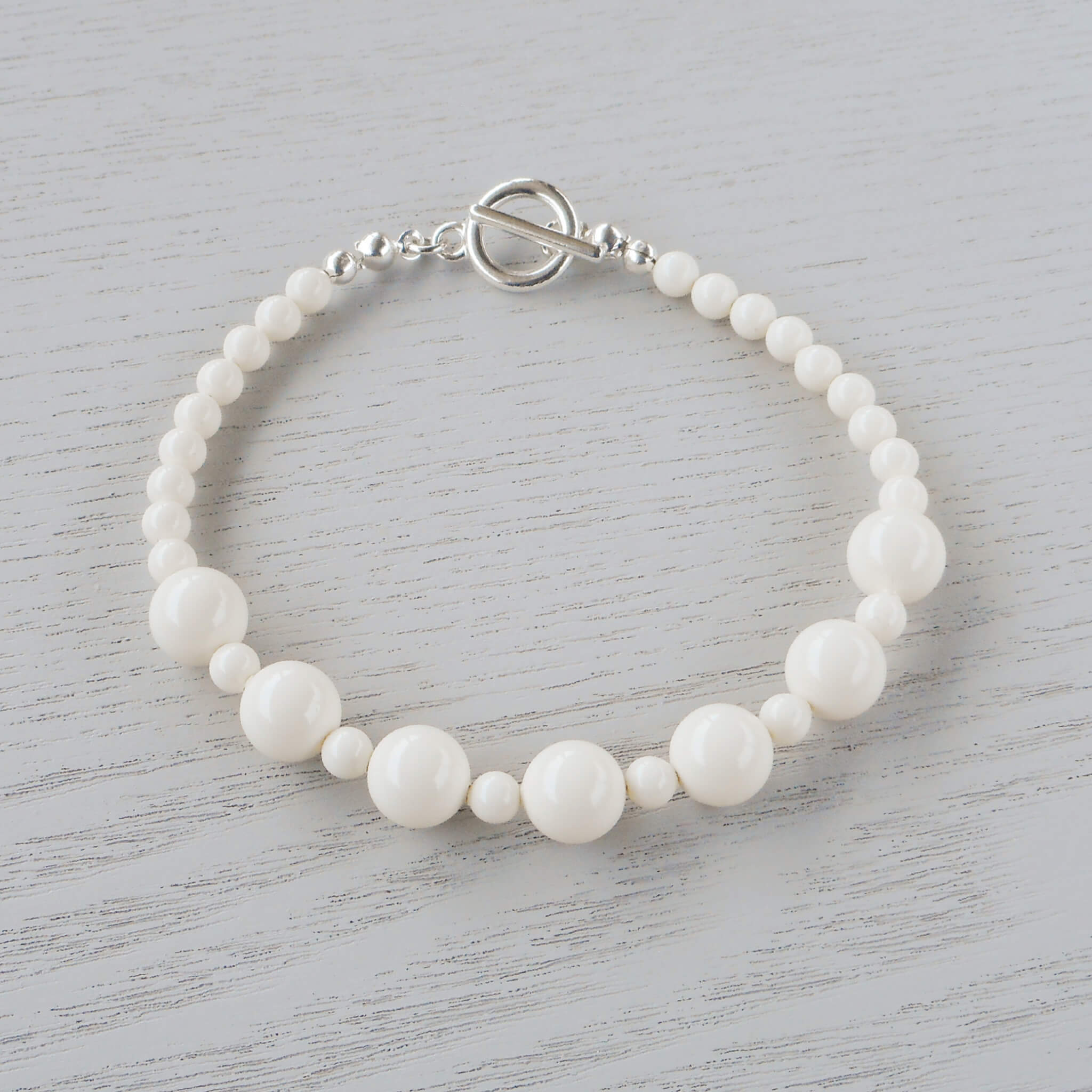 Ava Ivory Glass Crystal Bracelet The rich cream of 4mm & 8mm Ivory Swarovski glass pearls bring an Old World charm to this bracelet. 