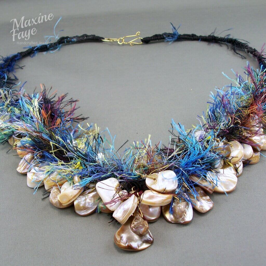 Hook and eye clasp on shell and fibre necklace