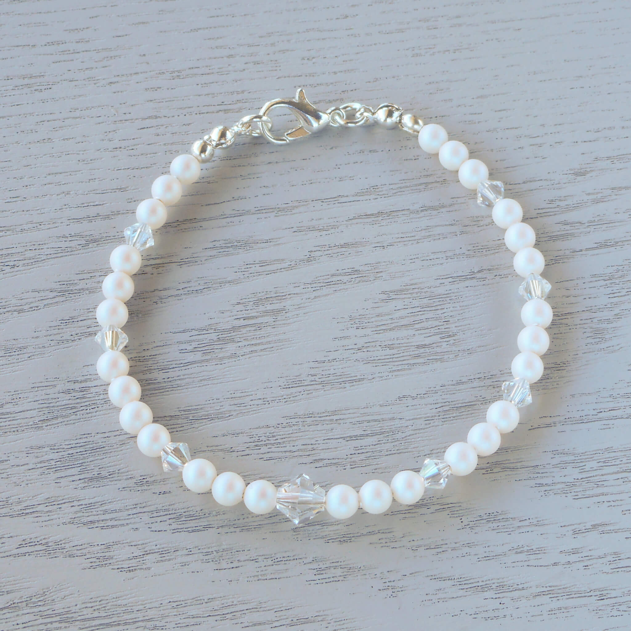Valentina Glass Crystal Bracelet Sets of Pearlescent White Swarovski pearls are separated by Swarovski crystal in Crystal Moonlight which