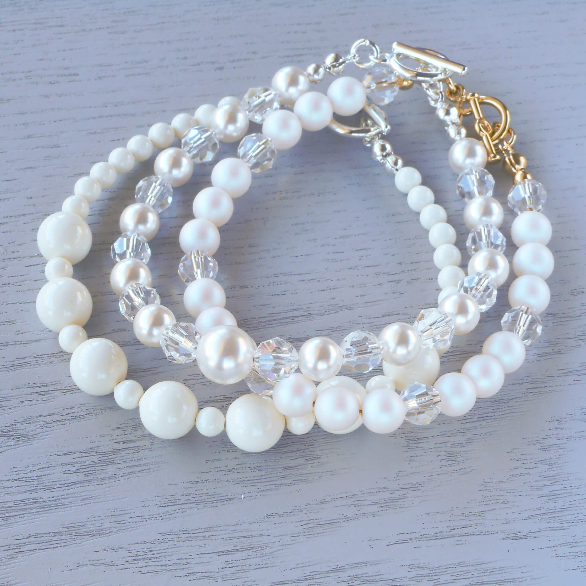 a stack of white pearl bracelet
